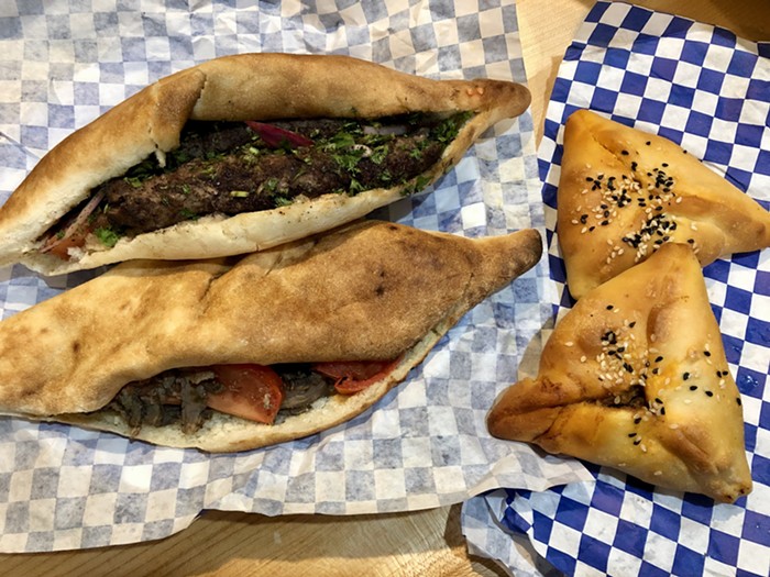 A kebob sandwich (top left), shawarma sandwich (bottom left), and a couple of meat pies (right).