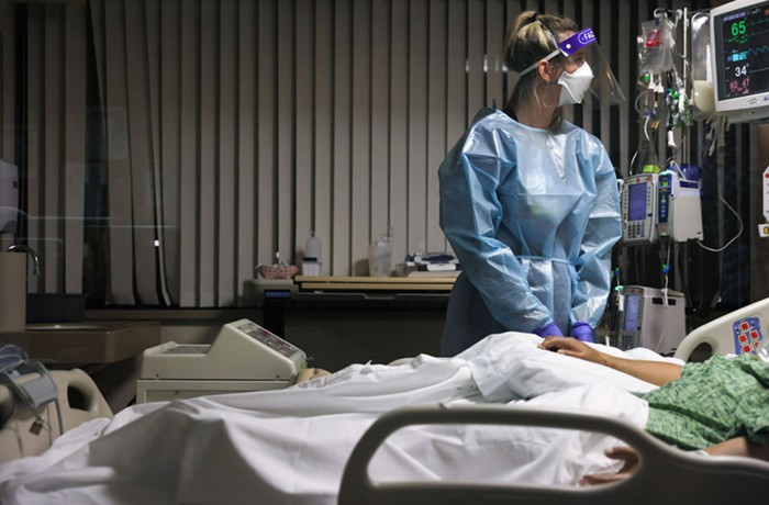 A nurse cares for a ICU patient in 2021 at a Providence medical Center in Southern California.
