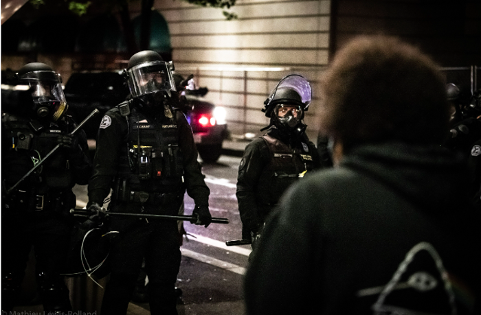 Portland police face a line of protesters during June demonstrations.