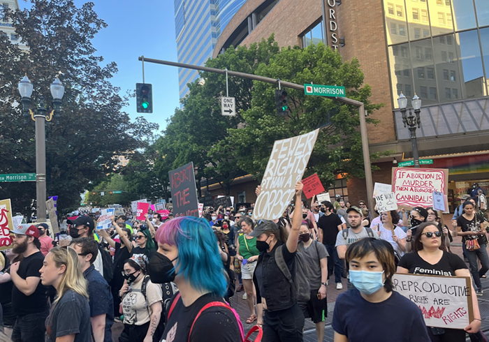 Protesters march through downtown Portland streets.